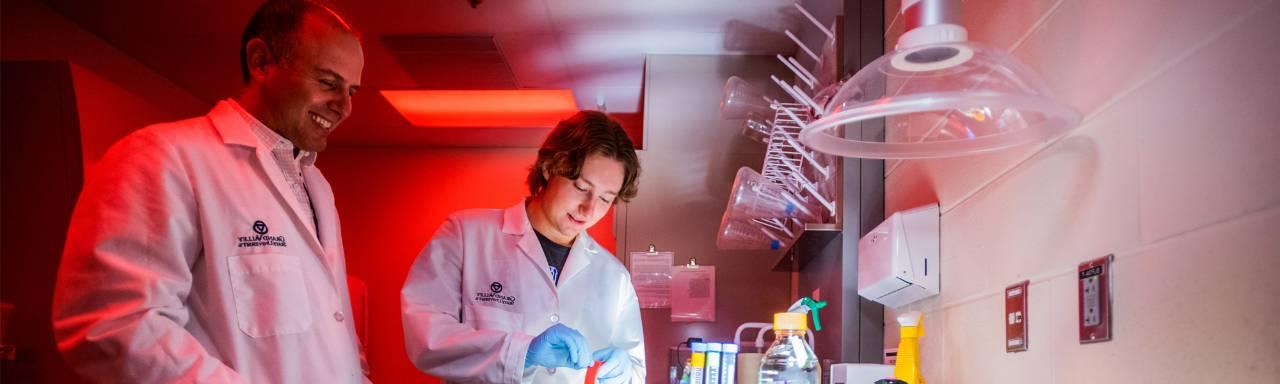 A GVSU professor works with a student in a medical laboratory.